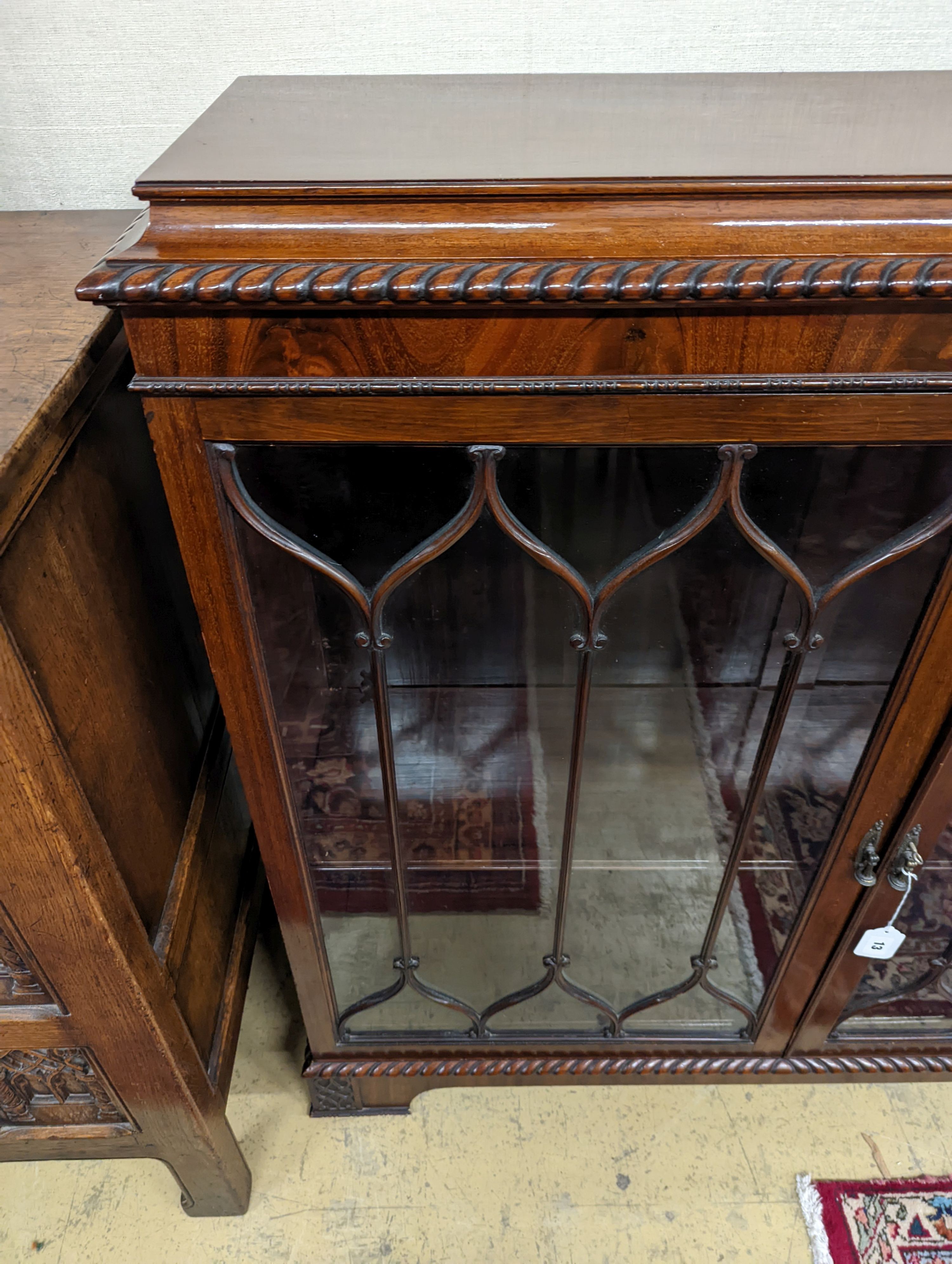 A 1920s mahogany low bookcase, in Chippendale style W-118cm, D-34cm, H-112cm.